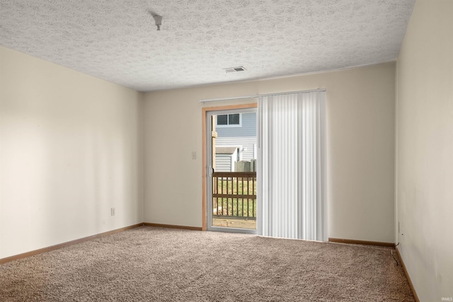 carpeted spare room featuring a textured ceiling