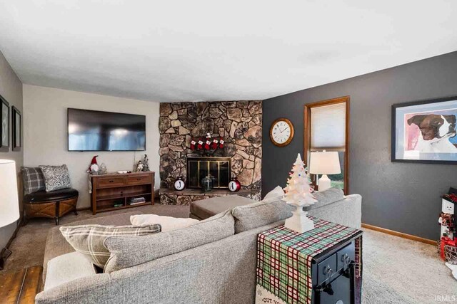 living room with a fireplace and carpet floors