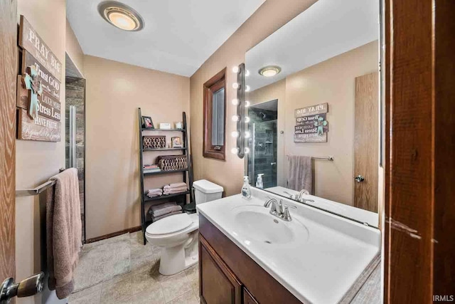 bathroom with toilet, vanity, and walk in shower