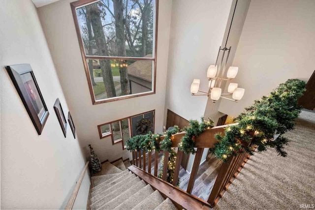 interior space with a towering ceiling and an inviting chandelier