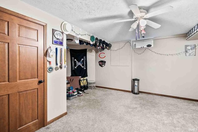 interior space featuring light carpet, a textured ceiling, and ceiling fan