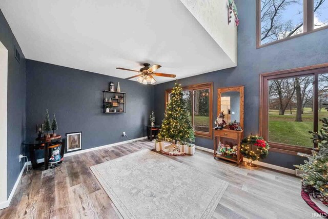 living area with hardwood / wood-style flooring and ceiling fan