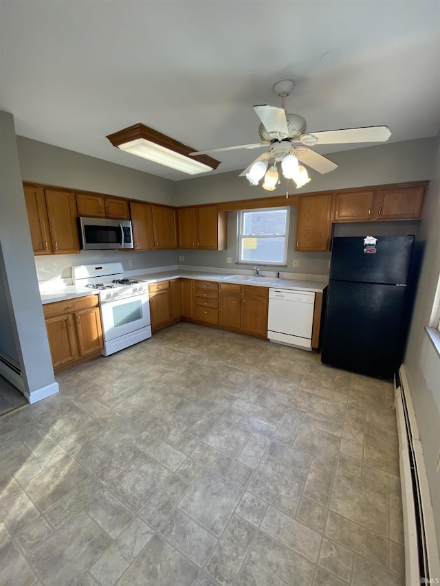 kitchen with white appliances, ceiling fan, a baseboard heating unit, and sink