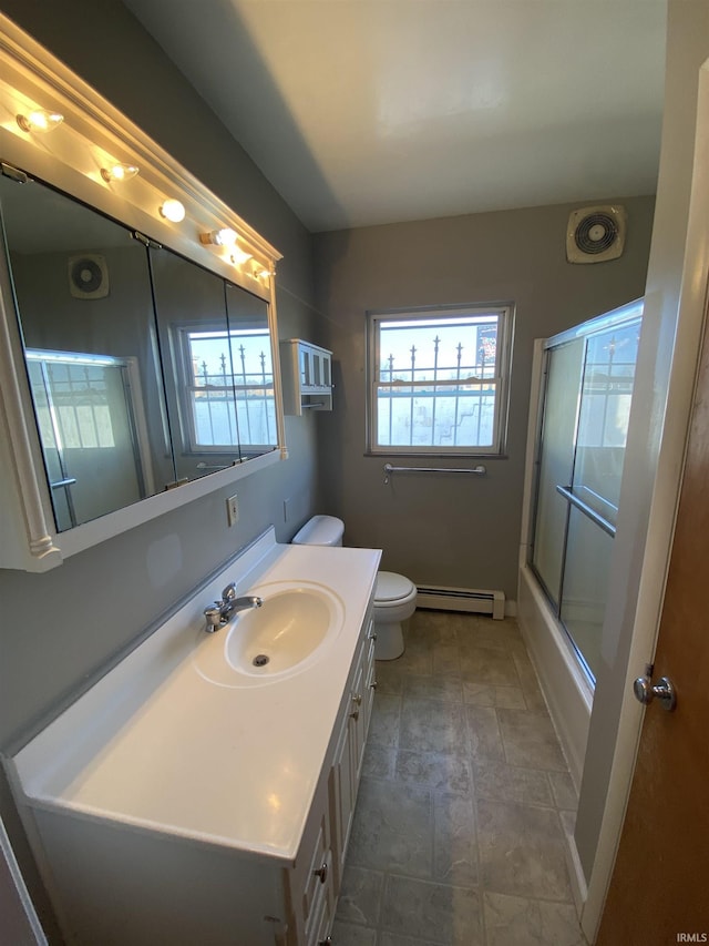 full bathroom with plenty of natural light, toilet, vanity, and a baseboard radiator