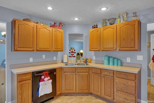 kitchen with dishwasher, a textured ceiling, and sink