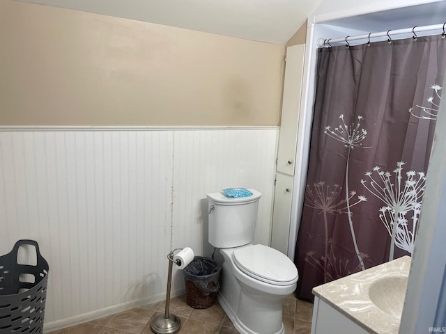 bathroom featuring tile patterned flooring, vanity, and toilet