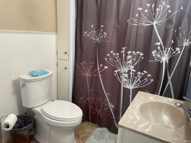 bathroom with tile patterned flooring, vanity, and toilet