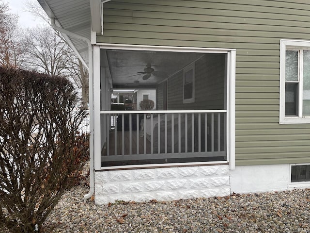 doorway to property featuring ceiling fan