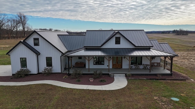 modern inspired farmhouse featuring a porch and a front lawn