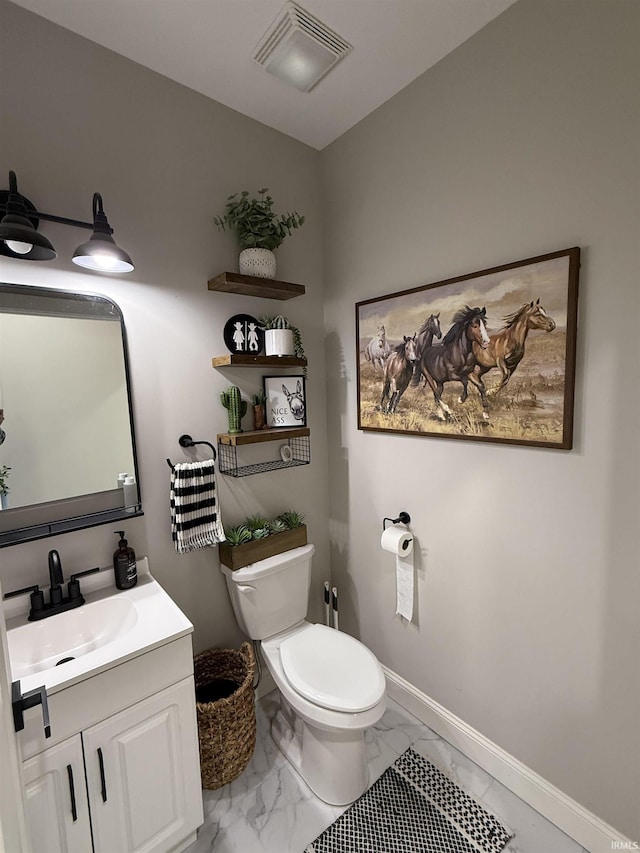 bathroom featuring vanity and toilet