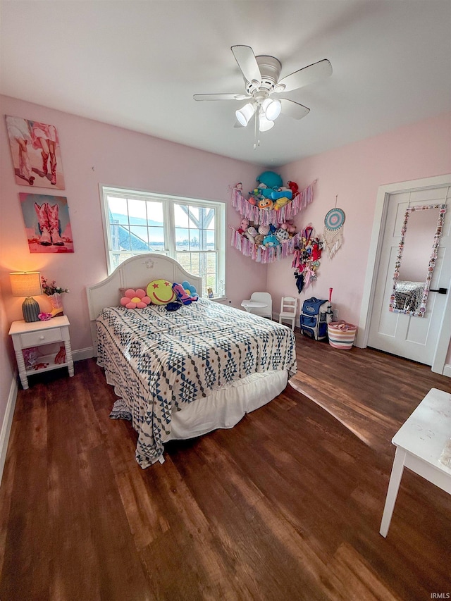 bedroom featuring ceiling fan and dark wood-type flooring