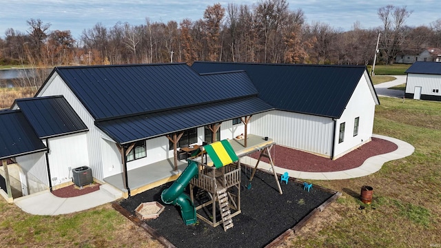 view of jungle gym with a yard and central air condition unit