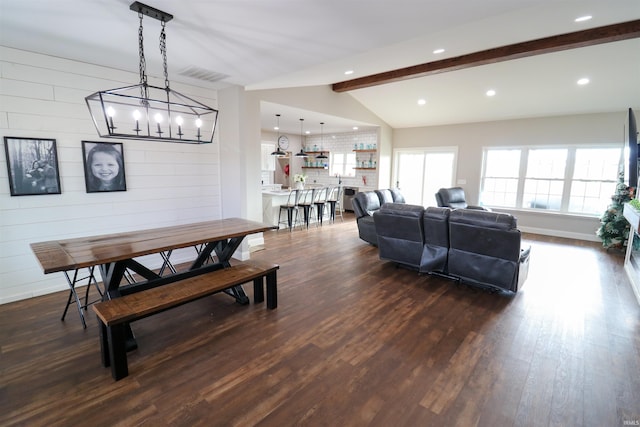 dining area featuring a notable chandelier, vaulted ceiling with beams, dark hardwood / wood-style flooring, and wooden walls