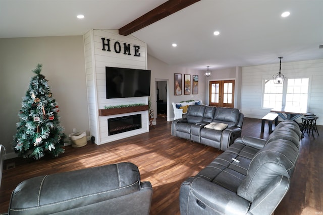 living room with vaulted ceiling with beams, a fireplace, dark hardwood / wood-style floors, and an inviting chandelier