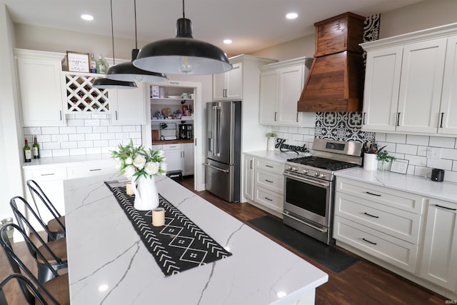 kitchen with white cabinetry, hanging light fixtures, and stainless steel appliances