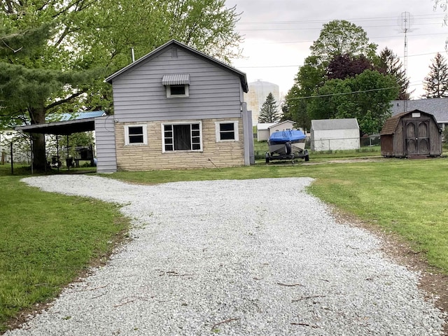 view of property exterior with a carport, a storage unit, and a yard