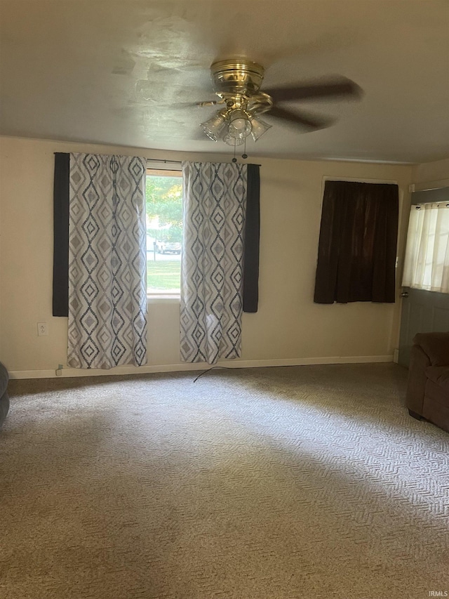 empty room with ceiling fan and carpet floors