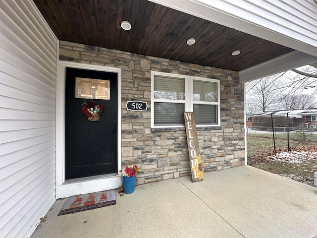 view of exterior entry with a porch