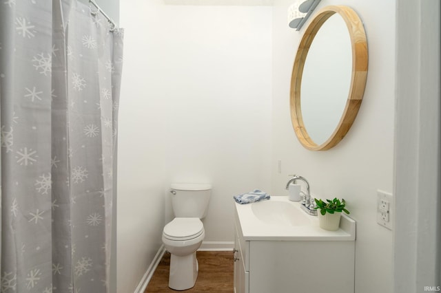 bathroom featuring vanity, toilet, and wood-type flooring