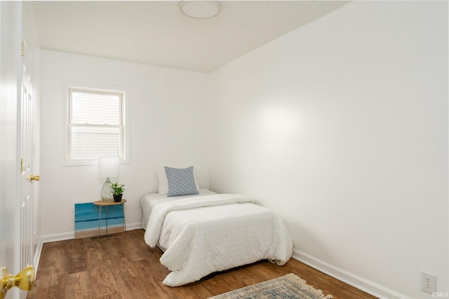 bedroom with hardwood / wood-style flooring