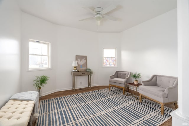 sitting room with ceiling fan and hardwood / wood-style flooring