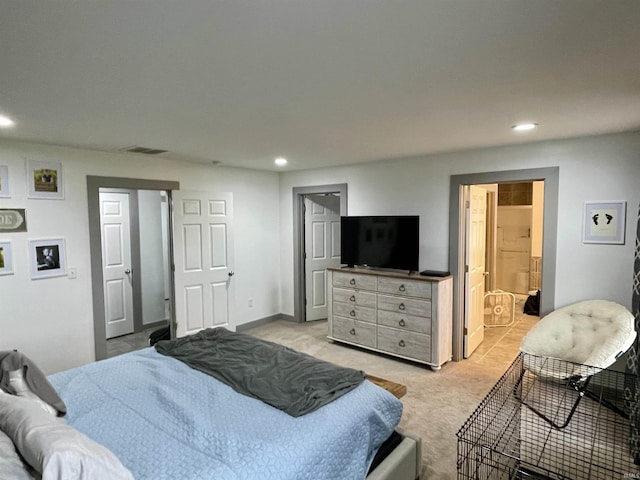 carpeted bedroom with ensuite bath