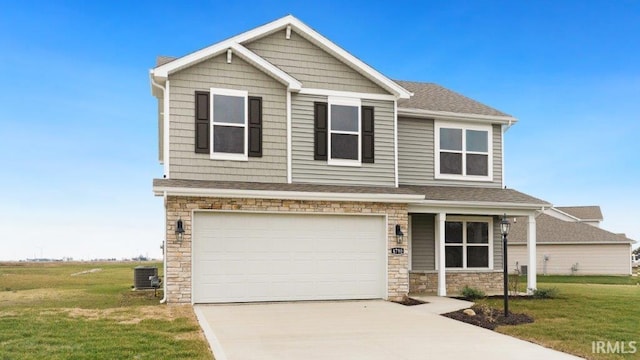 craftsman-style house with central AC unit, a garage, and a front yard