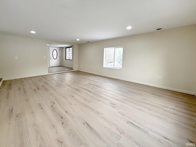 unfurnished room featuring plenty of natural light and light wood-type flooring