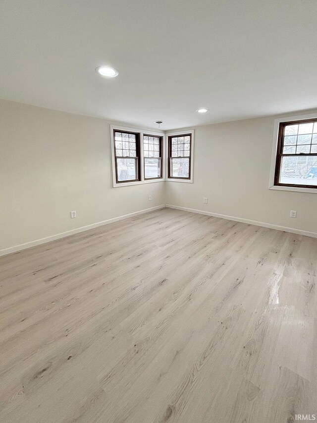 unfurnished room with light wood-type flooring