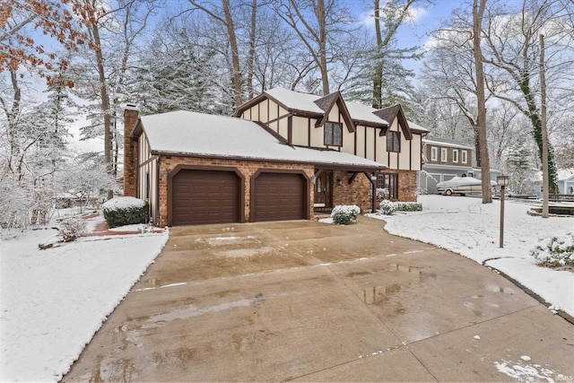 snow covered property featuring a garage