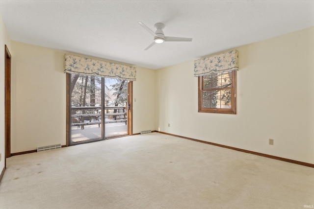 carpeted empty room featuring ceiling fan