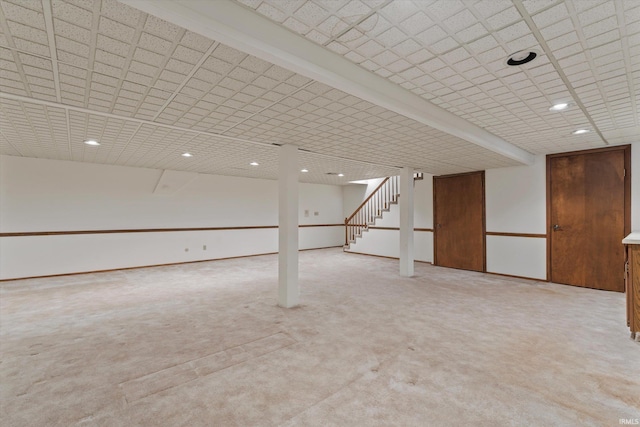 basement featuring light colored carpet