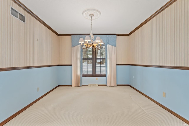 unfurnished dining area with a notable chandelier, carpet floors, and crown molding