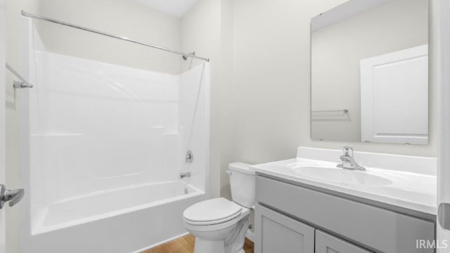 bathroom featuring bathtub / shower combination, vanity, toilet, and wood finished floors