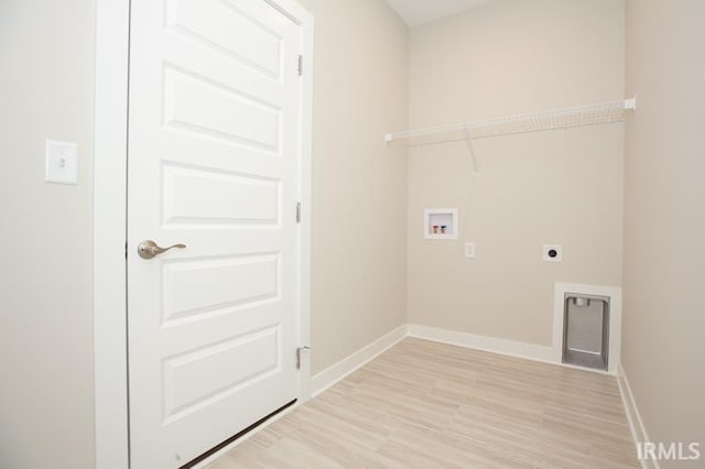 washroom with hookup for a washing machine, light hardwood / wood-style flooring, and hookup for an electric dryer