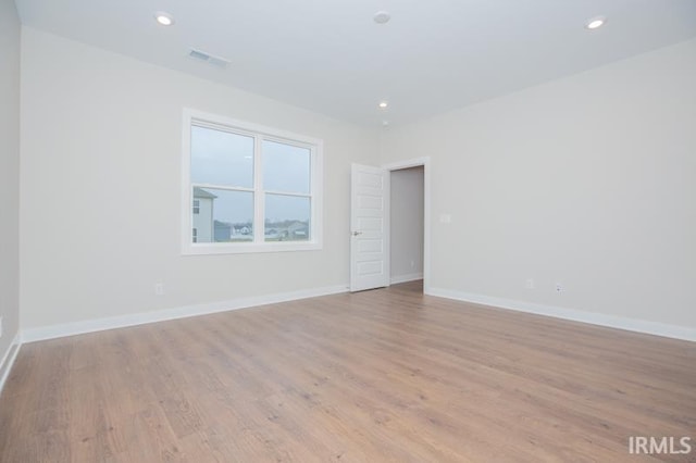 unfurnished room with light hardwood / wood-style floors