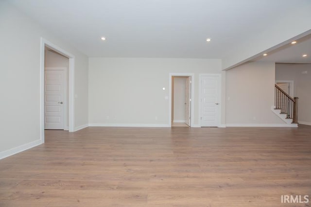 unfurnished room with light wood-type flooring