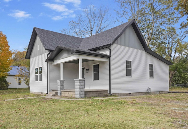 view of home's exterior featuring a yard and covered porch