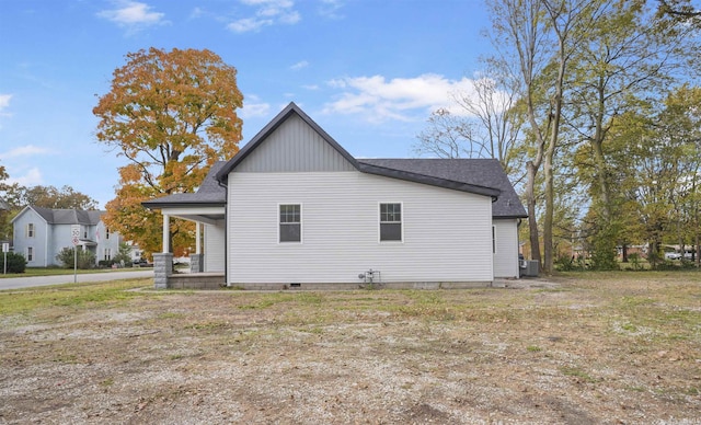 view of side of property featuring central AC unit and covered porch