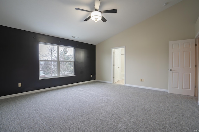 carpeted spare room with ceiling fan and lofted ceiling