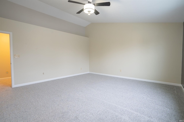 spare room featuring carpet flooring, ceiling fan, and vaulted ceiling