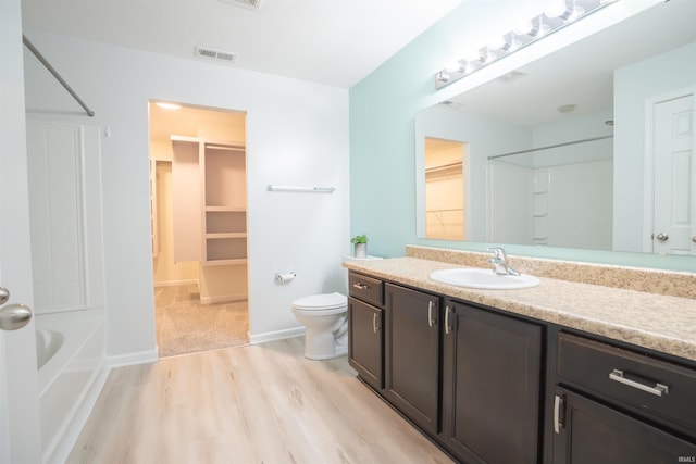 bathroom featuring wood-type flooring, vanity, and toilet