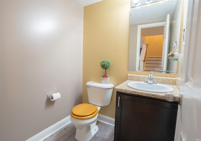 bathroom featuring hardwood / wood-style floors, vanity, and toilet