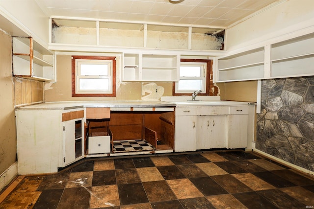 kitchen featuring white cabinetry, a wealth of natural light, and sink