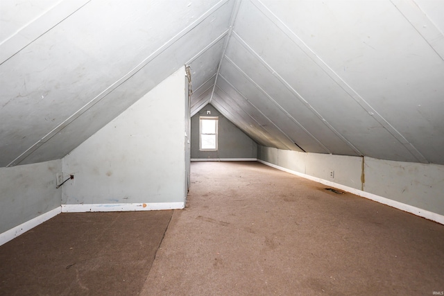 additional living space featuring lofted ceiling