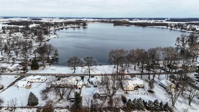 snowy aerial view with a water view