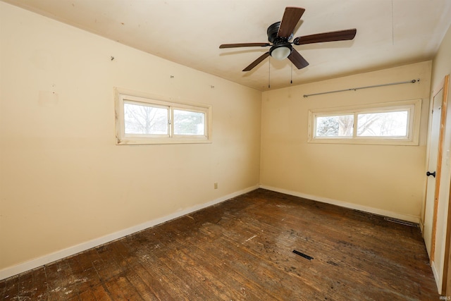 unfurnished room with dark hardwood / wood-style floors, a wealth of natural light, and ceiling fan