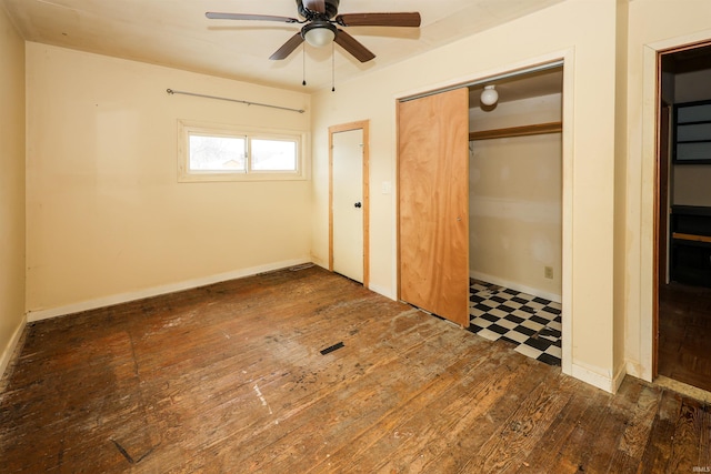 unfurnished bedroom featuring ceiling fan and dark wood-type flooring