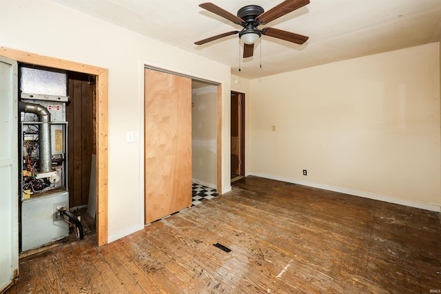 unfurnished bedroom with ceiling fan, a closet, and dark wood-type flooring