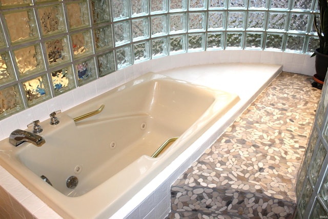 bathroom with a relaxing tiled tub